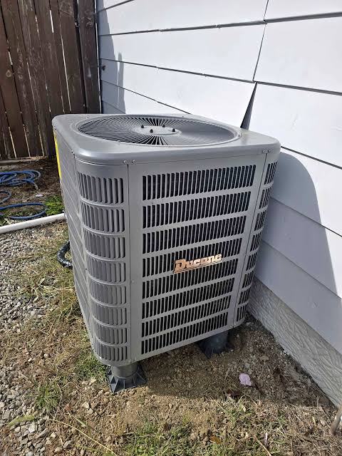Outdoor air conditioner unit beside a house